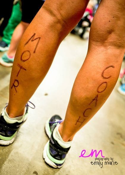 Legs with marker that says MOTR Coach