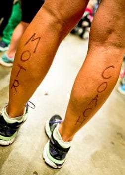 Legs with marker that says MOTR Coach