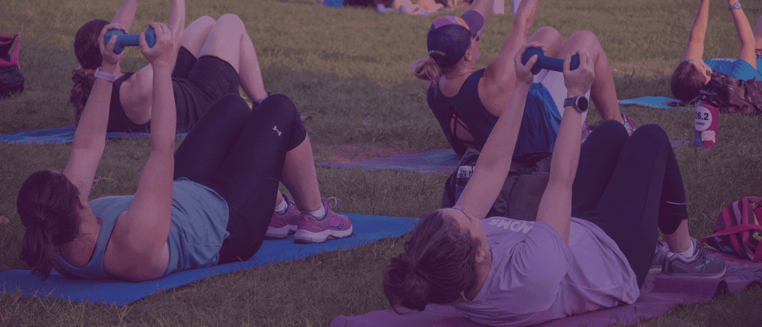 Women holding up weights on mats