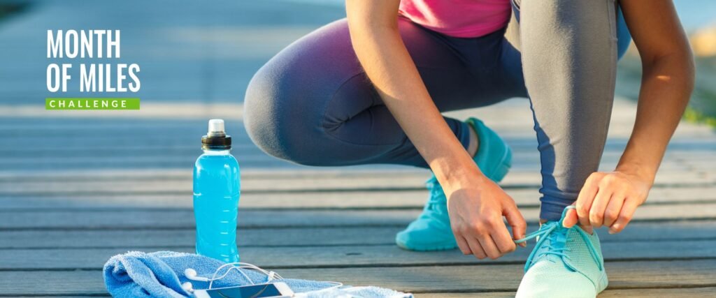 runner tying shoes with water bottle